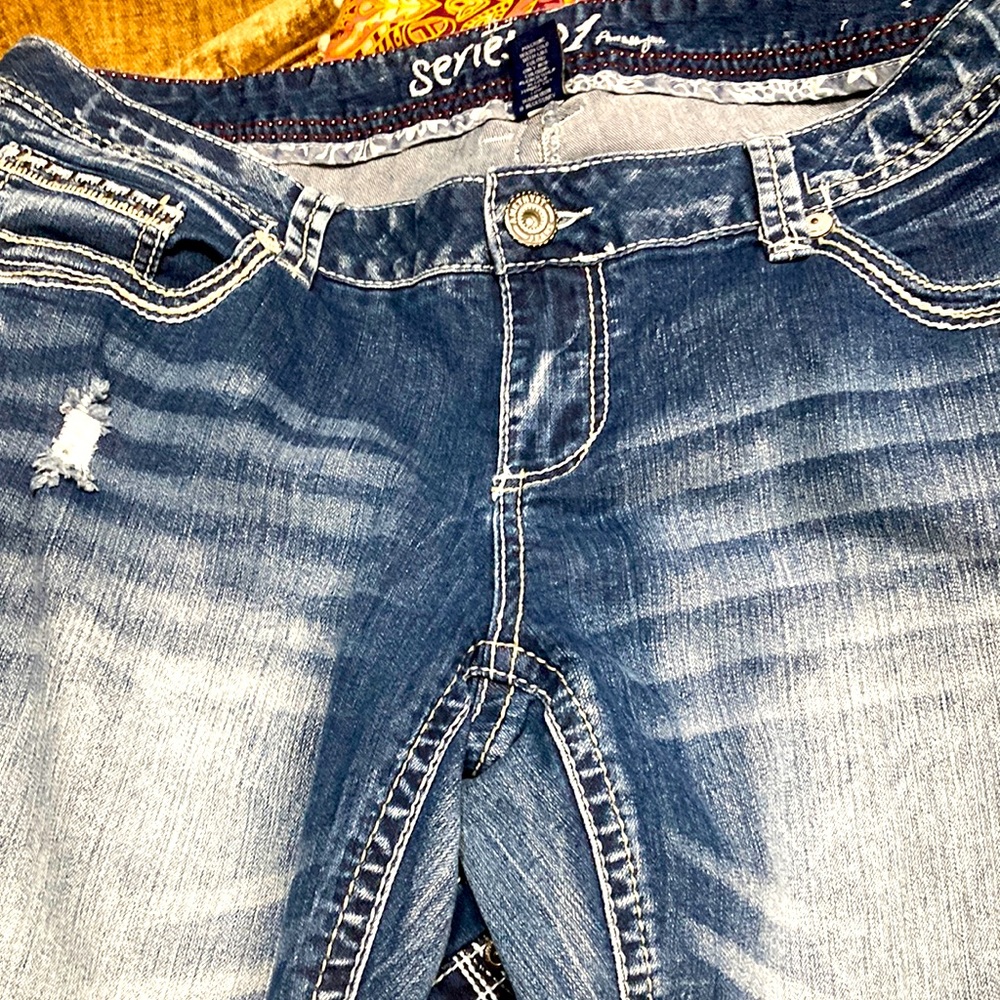 Blue distressed flare leg jeans w/rhinestones.